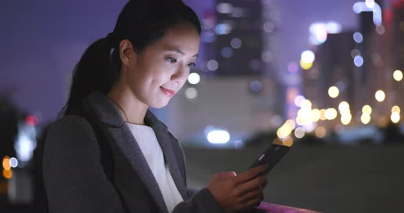 Woman Use of Mobile Phone in City at Night