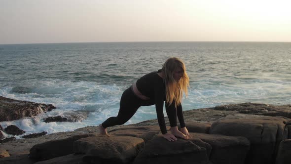 Girl with Long Loose Hair Stretches Against Endless Sea