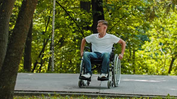 A Guy in a Wheelchair on the Pedestrian Path