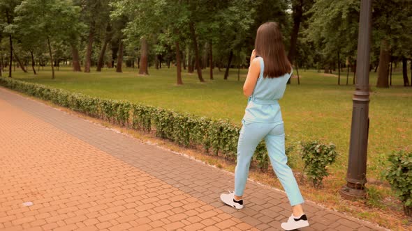 Trendy Girl in Comfortable Shoes Stroll in Park