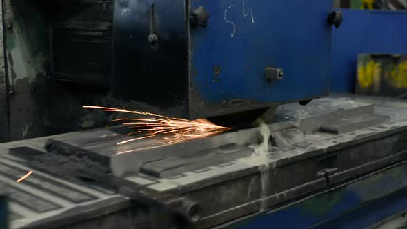 Work of an Industrial Surface Grinding Machine. Grinding of a Flat Metal Part