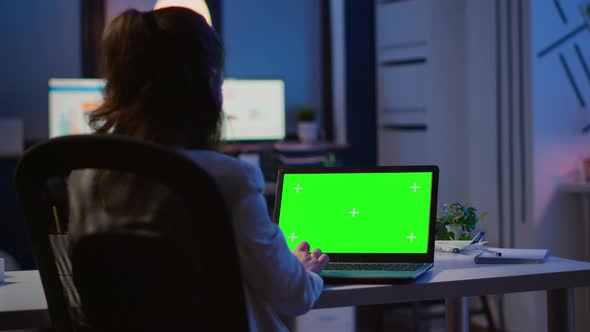 Back View of Business Woman Looking at Green Screen Laptop