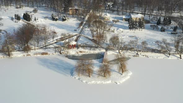 lAn island on a lake with a bridge in the winter Loshitsky Park.Minsk, Belarus