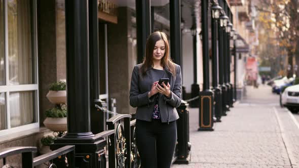Beautiful Businesswoman on Street Using Smartphone App, Surfing Internet, Slow Motion