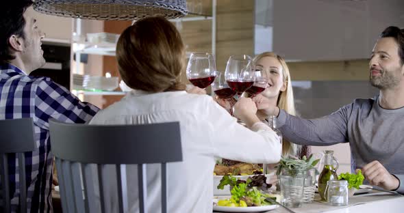 Italian People Making Toast Together with Red Wine