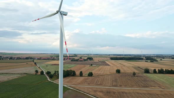 Windmill Turbine in the Field at Summer Day