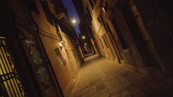 Silhouettes of People Walking in Narrow Venetian Street