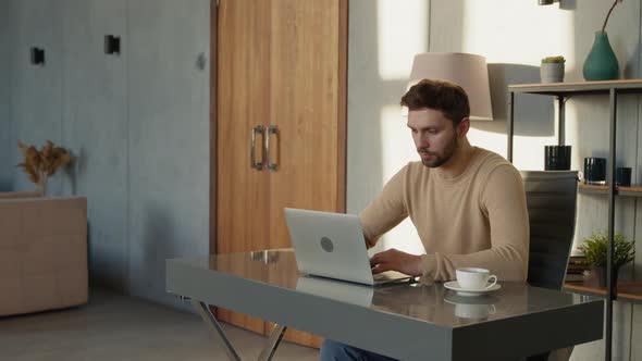 Handsome worker with laptop computer indoor