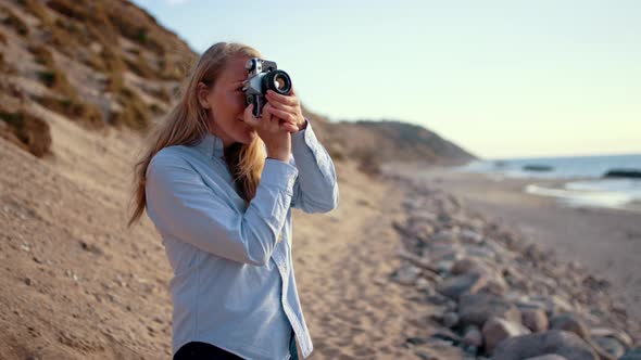 Photographer Using Slr Camera On Beach