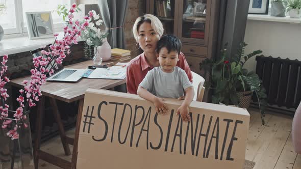 Asian Mother and Little Son with Stop Asian Hate Sign