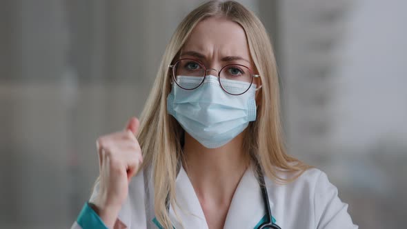 Female Doctor in Medical Mask Looking at Camera Talking Angry Show Index Finger No Negative Gesture