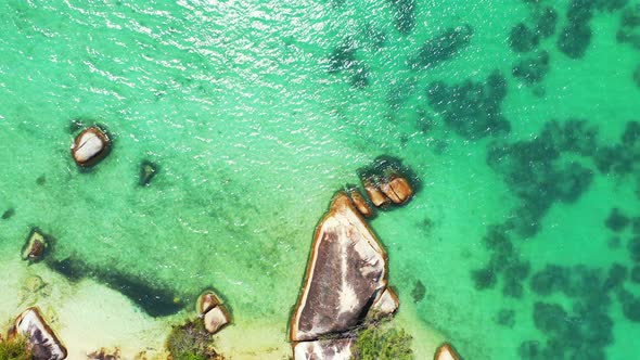 Tropical azure sea with rocky shore. Aerial background, luxury holiday concept