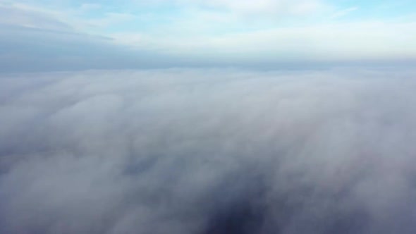 Aerial Drone View Flight Over Above Fog Mist and Roofs of Buildings in City