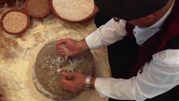 Crushing Wheat With Turning Stone To Make Flour 1