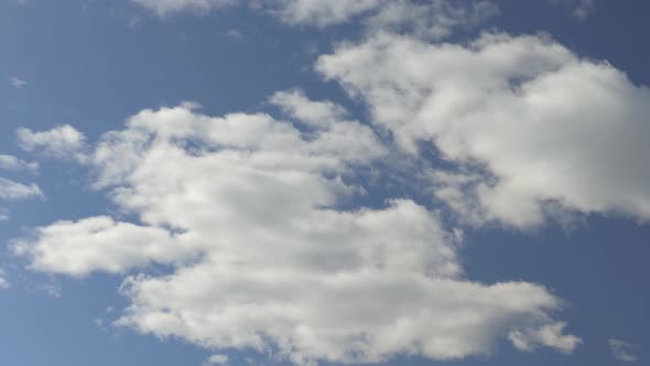 White Clouds Move Across a Beautiful Blue Sky. Nice Sunny Weather