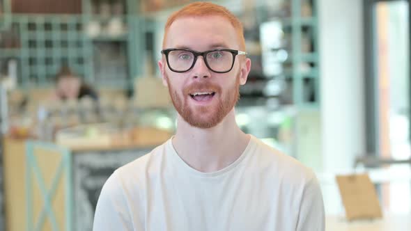 Portrait of Redhead Man Shaking Head Yes Sign