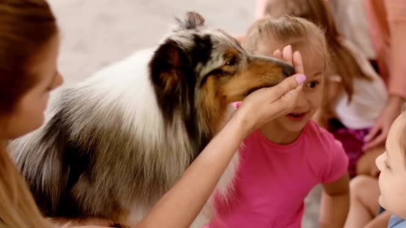 Happy kids playing with therapy dog