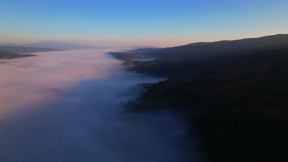 Flying over the clouds during morning sunrise