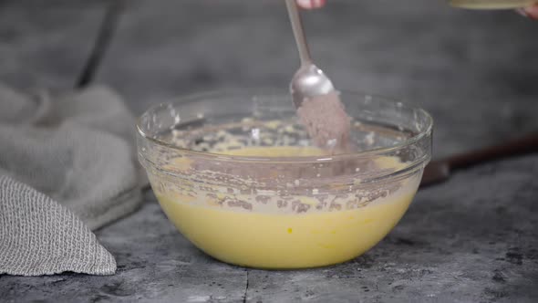 Female Hands Mixing the Chocolate Batter for Cake