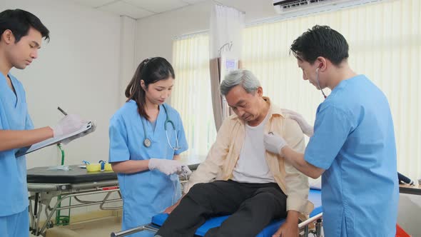 Asian medical team doctors nurse examining and checking Asian elderly male patient