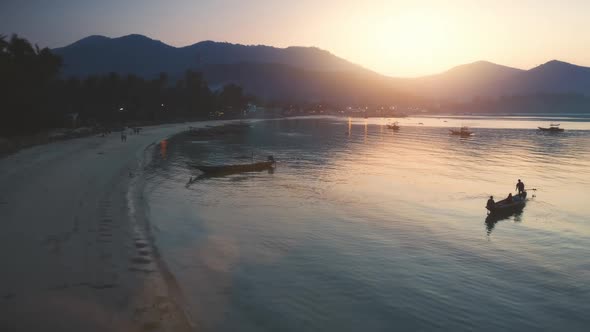 Evening Beach with Palm Trees Sunset Over Mountains Aerial View