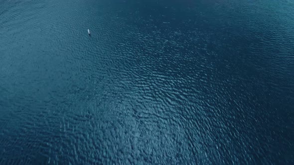 Drone flies over the water surface of the lake, aerial view of Lake Arrowhead, California, USA