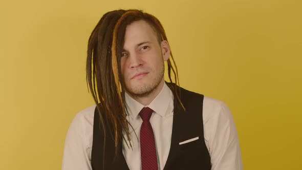 Young Handsome Man Looking at Camera on Yellow Background