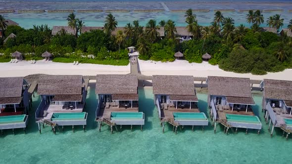 Aerial drone panorama of shore beach time by clear lagoon and sand background