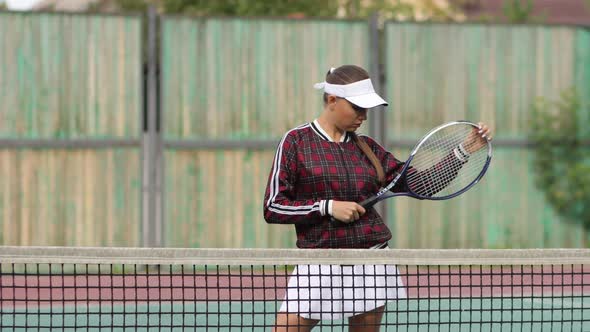 Seductive Confident Woman Playing Tennis on Court