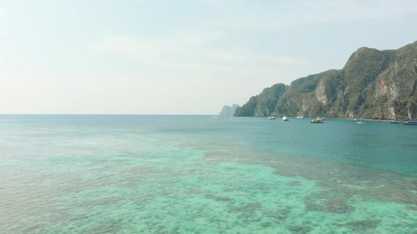 Shallow warm Emerald green sea covering the vastness of Ko Phi Phi Don Island Coast in Thailand