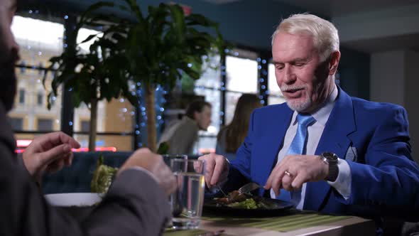 Portrait of Man Enjoying Meal and Conversation