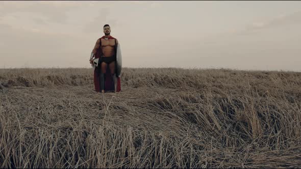 Shirtless Gradiator Posing in Dry Field