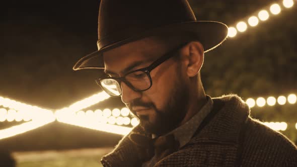 Smiling Pensive Young Arab American Man in Black Hat Eyeglasses Isolated on Yellow Background Studio