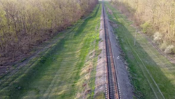 Flight over rail and rail sleepers in spring when grass is green. Travel by rail.