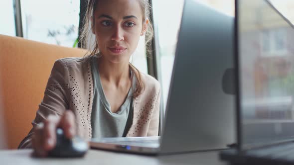 Young Woman Surfing or Looking Content at Laptop