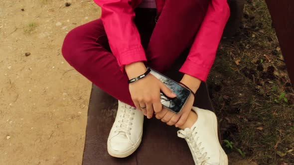 Girl with red jacket sitting in the park