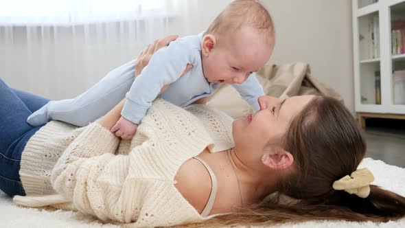 Cute Smiling Baby Boy Lying on Mother and Looking at Her