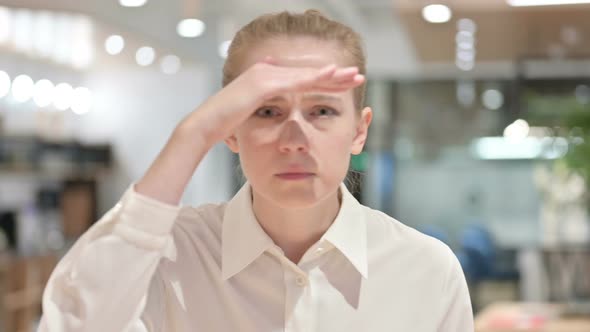 Portrait of Curious Young Businesswoman Searching for Something 