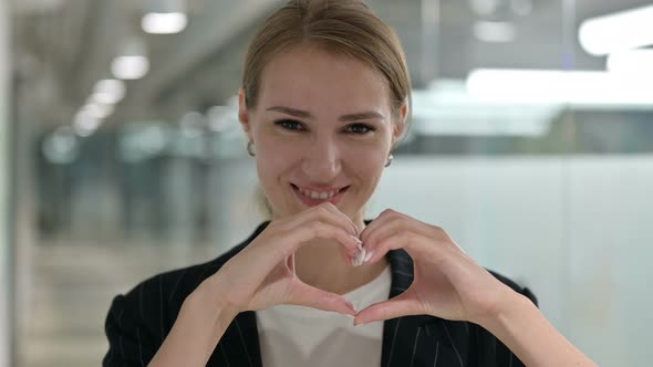 Portrait of Businesswoman Showing Heart Sign with Hand