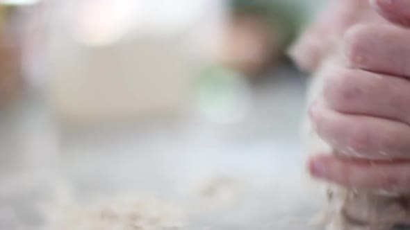 Close up on Mom's hands as she kneads the dough.