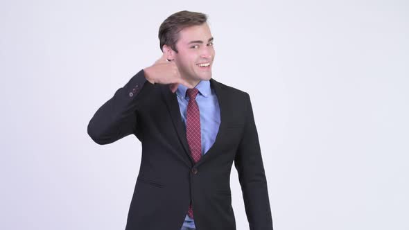 Young Happy Handsome Businessman with Call Me Gesture