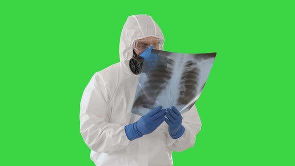 Medic in White Hazmat Protective Suit Checking and Scanning Lunges X-ray Looking for Epidemic Virus