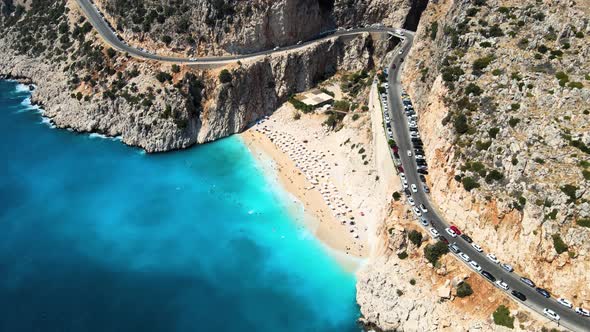 Flying drone close-up over the water surface of the mountain serpentine small beach hidden at the fo