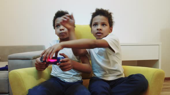 Two Little Black Boys Brothers Playing a Game and Take Away the Joystick From Each Other