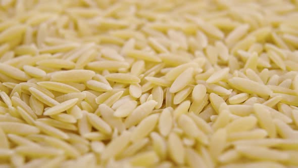 Dry barley falling in a heap. Macro. Slow motion