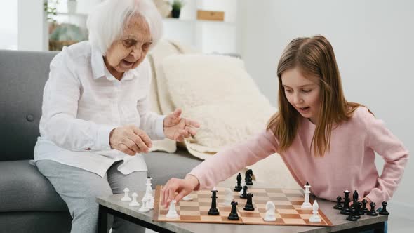 Grandmother Playing Chess with Granddaughter