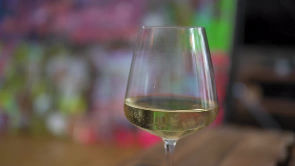 Closeup of a glass of white wine or Champagne, at bar or restaurant