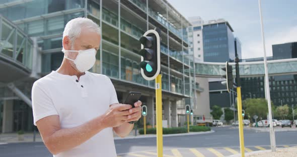 Caucasian man out and about in the street wearing on a face mask against coronavirus