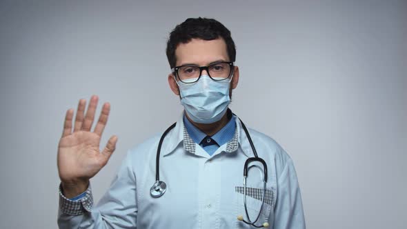 Happy Young Arabic Bearded Man Doctor Waving Hand