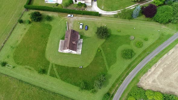 Riding lawn mower in action seen from the sky